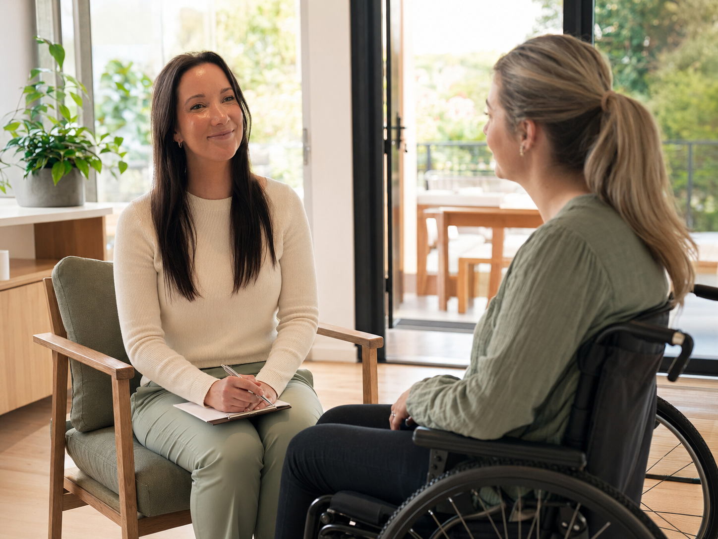 Sarah having a relaxed conversation with an adult wheelchair user